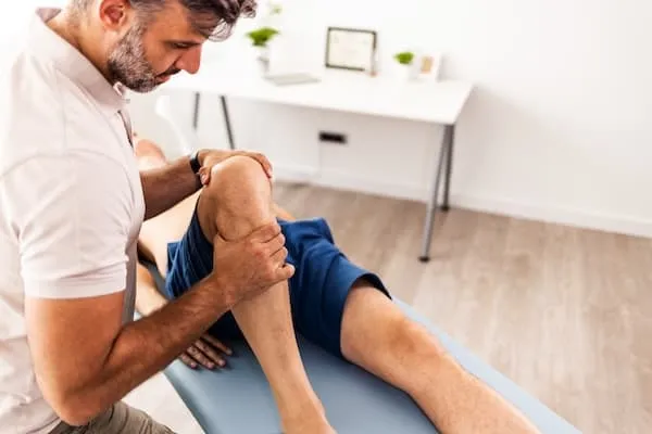 Provider helping with a patient's knee